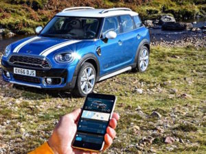 MINI Countryman with mobile phone showing new MINI Connected app