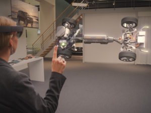 Woman using Microsoft HoloLens technology to see chassis of new Volvo S90